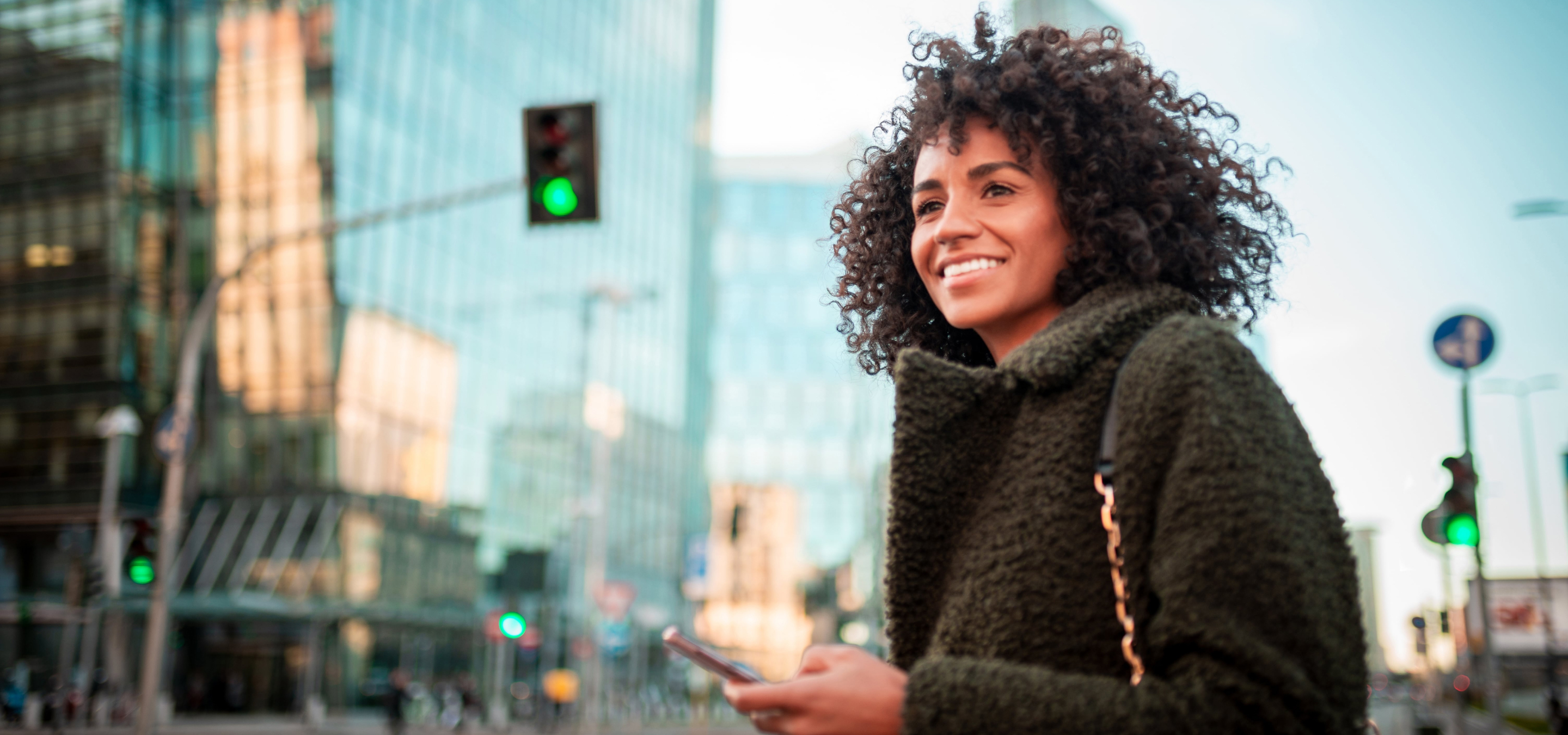 Woman in a city looking hopefully into the future 