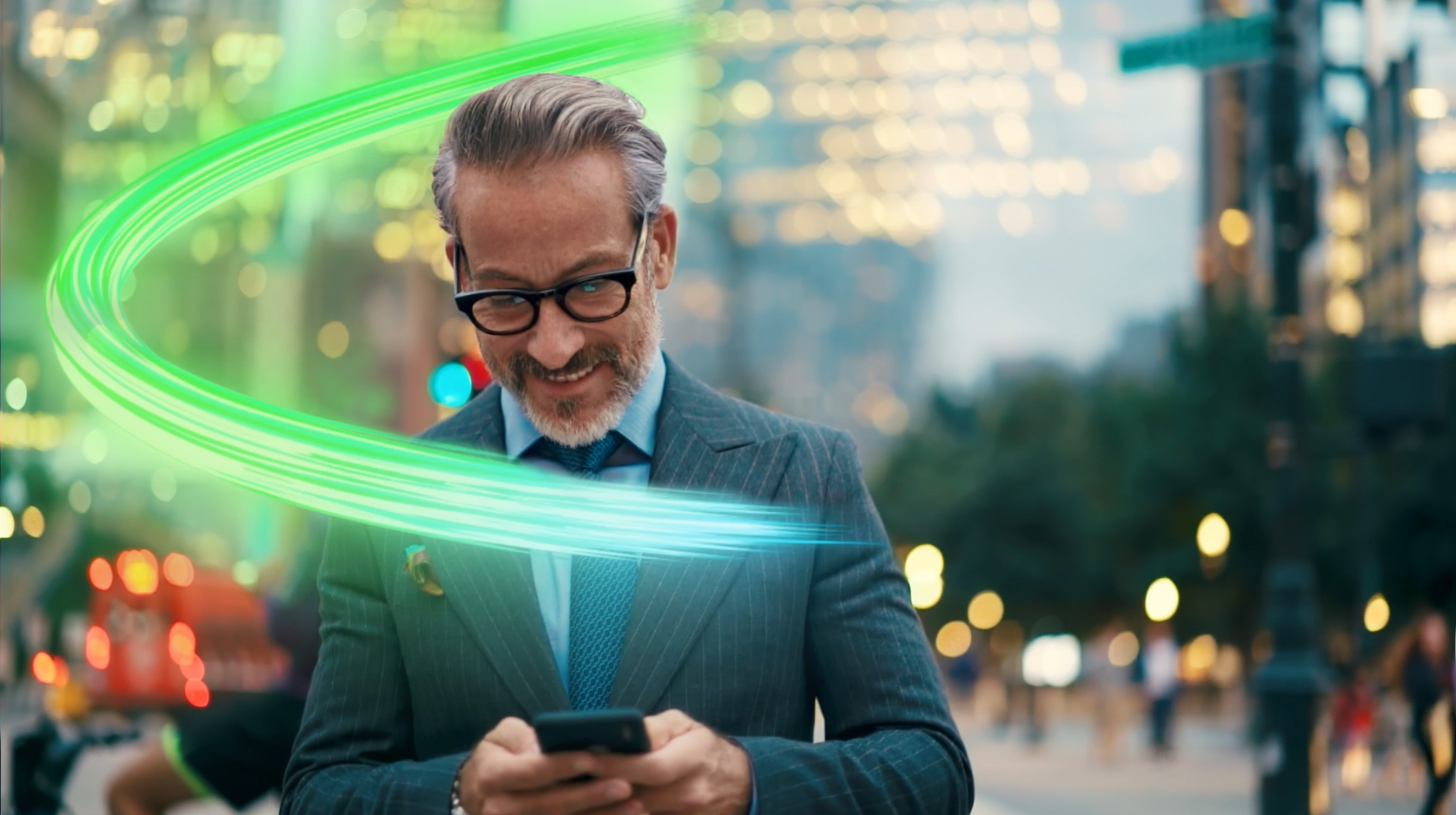 A businessman transacts with confidence while on his commute. He smiles down at his phone.