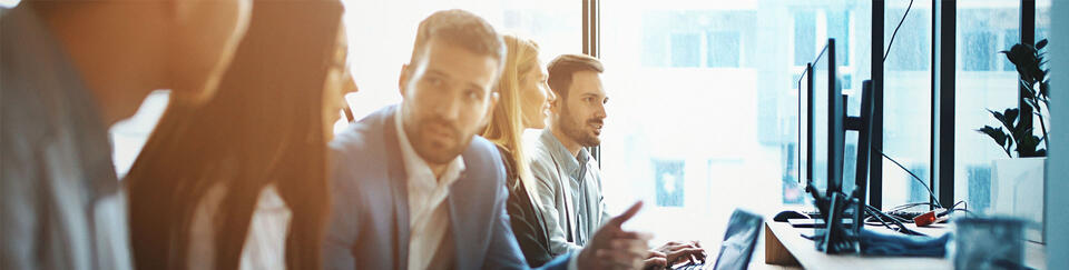 group of people talking at computers