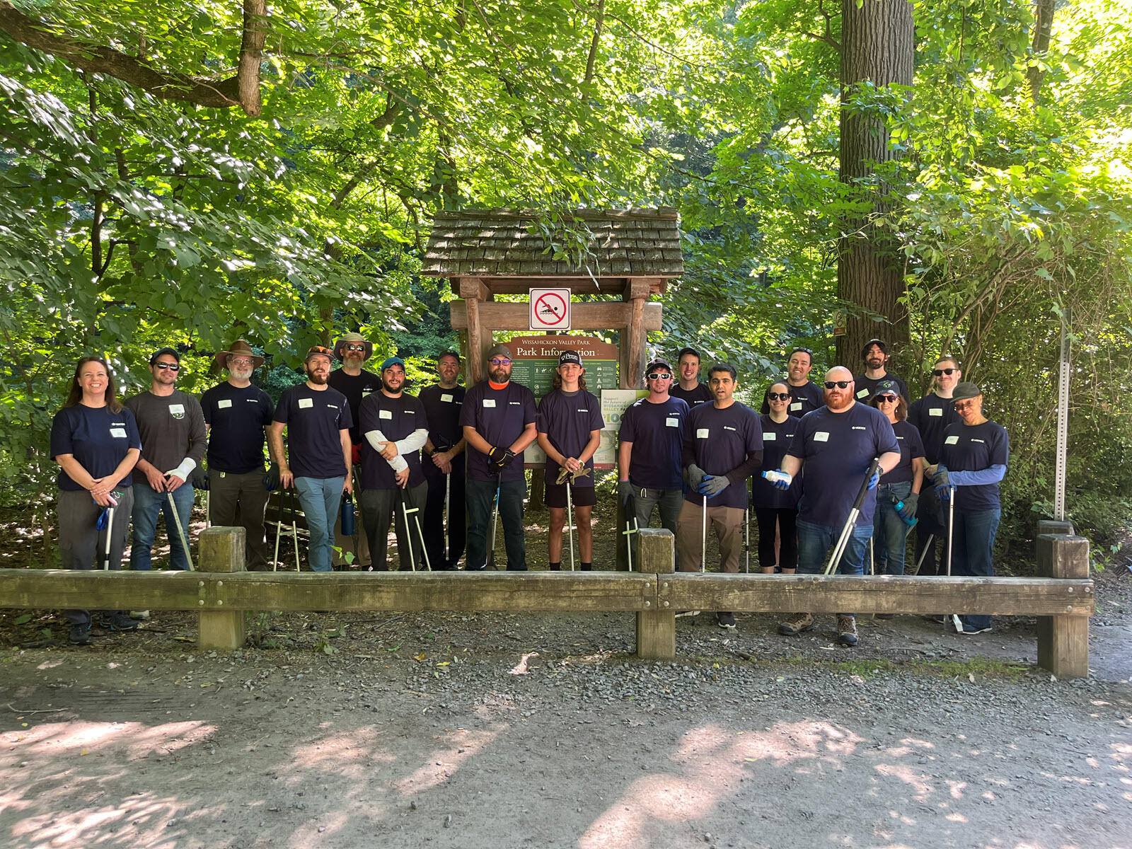 Vertex employees volunteer to collect trash at a local outdoor site.